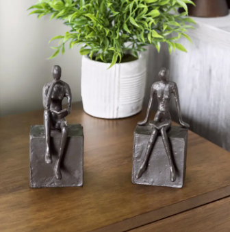 MAN AND WOMAN READING ON A BLOCK CAST IRON BOOKEND SET