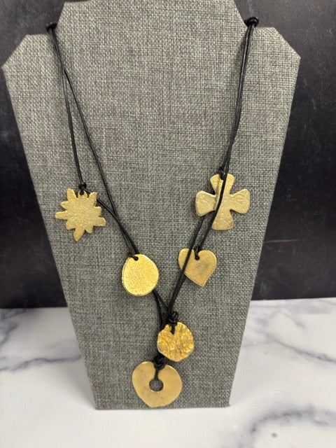 VINTAGE GOLD TONED HAMMERED METAL CHARM NECKLACE ON LEATHER CORD NECKLACE
