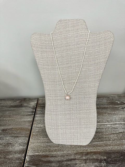 NANCY SCOFIELD JEWELRY - SHELL PEARL DANGLING FROM A NECKLACE OF FRESHWATER RICE PEARLS